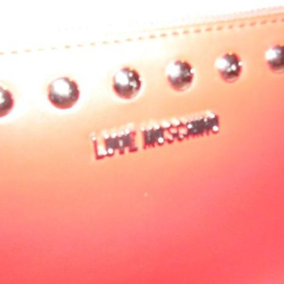 AMAZING, NWT, Moschino, true red leather, retro, clutch or cosmetic bag with chrome studs, a zip top closure, an XL engraved chrome zipper fob, and polished chrome hardware