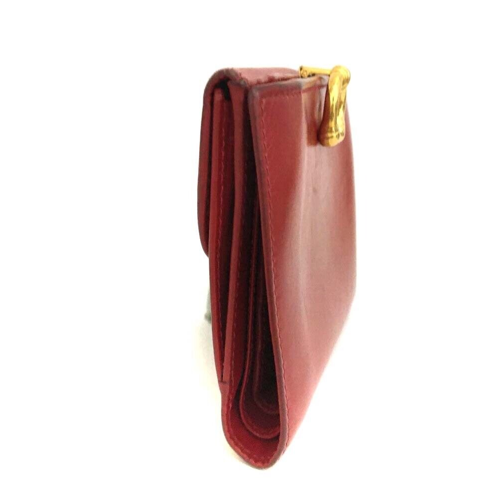 Gucci, red leather, bi-fold style, wallet with multiple pockets, tons of card slots, & a gold, engraved 'GUCCI' horseshoe accent
