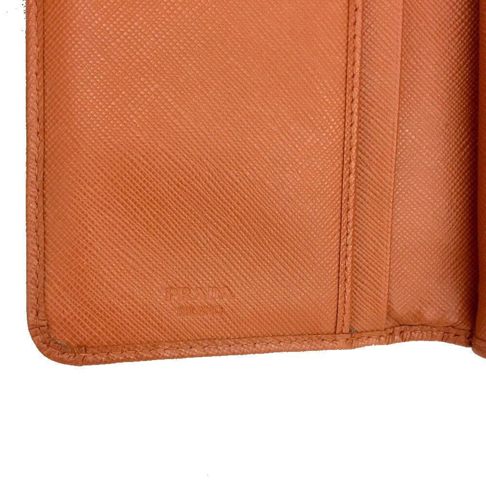 PRADA, burnt orange, saffiano leather, zip around style, large wallet w lots of compartments, zip pockets, card slots, & gold hardware