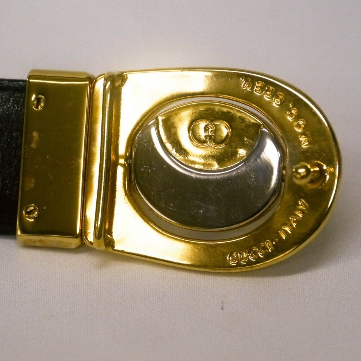 Vintage, Gucci, 44" long x 1.25" wide, brown or black leather, reversible belt in size 40" with a dual sided, two-tone engraved GG buckle