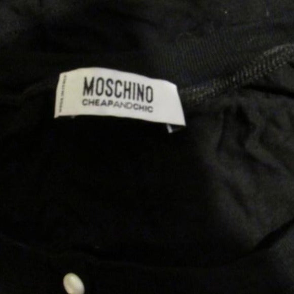 Moschino, size 10, black, 100% rayon knit top with a scoop neck, four button front placket, pearly buttons, and red, brown, white, black abstract floral print cap sleeves