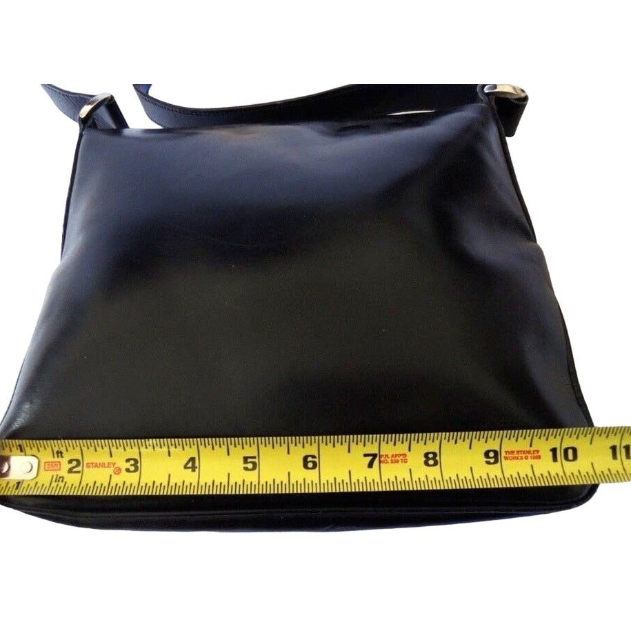 1970s Gucci saddle bag in black leather with muted gold hardware, an expandable bottom, wide shoulder strap, and burgundy leather lining