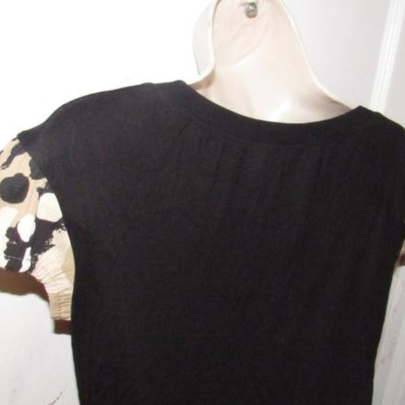 Moschino, size 10, black, 100% rayon knit top with a scoop neck, four button front placket, pearly buttons, and red, brown, white, black abstract floral print cap sleeves