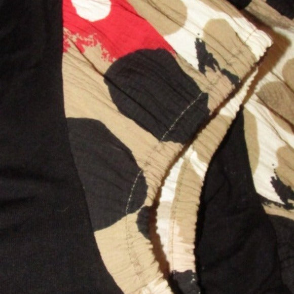Moschino, size 10, black, 100% rayon knit top with a scoop neck, four button front placket, pearly buttons, and red, brown, white, black abstract floral print cap sleeves