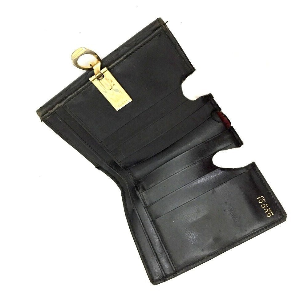Gucci, blsck glossy leather, bi-fold style, rectangular, wallet with multiple pockets, tons of card slots, and a gold, hinged G clasp