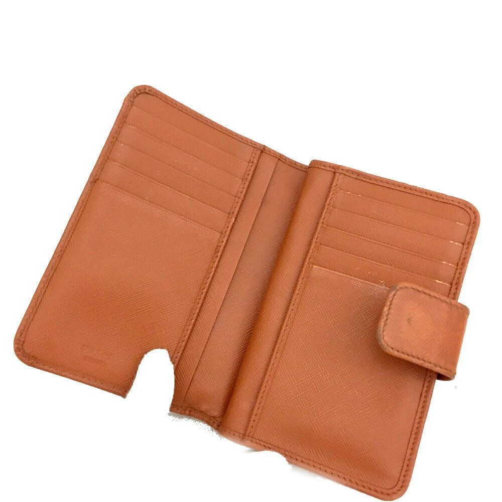 PRADA, burnt orange, saffiano leather, zip around style, large wallet w lots of compartments, zip pockets, card slots, & gold hardware