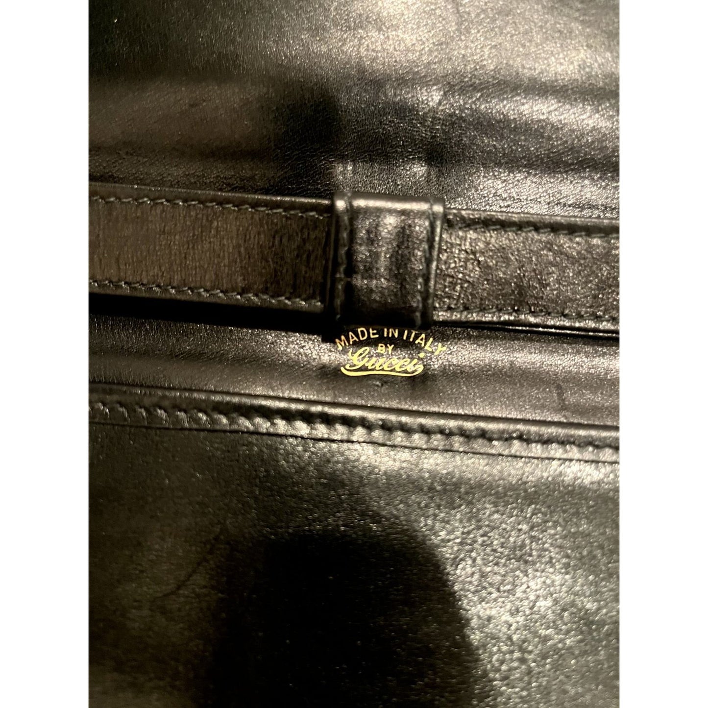 Vintage, rare, black leather, Gucci shoulder bag with a large, two-tone 'GG' emblem and removable strap