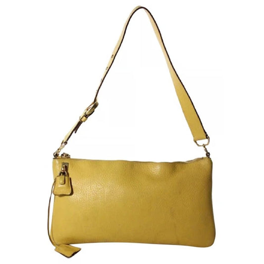 Vintage 90s Prada, yellow leather, hobo-style satchel with top zip, gold hardware, & padlock/keys