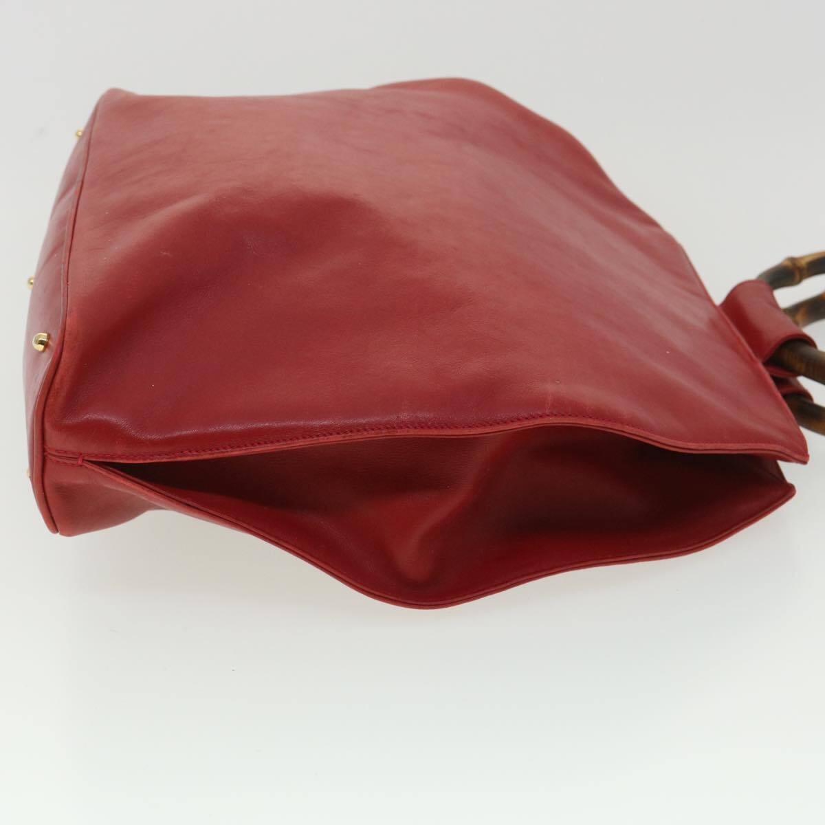 Vintage, mod look, Gucci, true red leather shopper with two round bamboo handles, a footed bottom, and gold accents