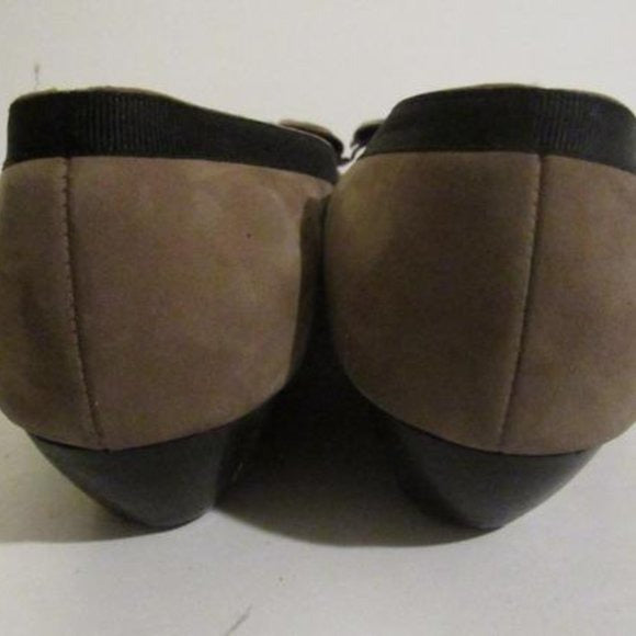 Salvatore Ferragamo VARA brown suede flats with black trim, large, fringe bows at the toes, and low, wedge heels