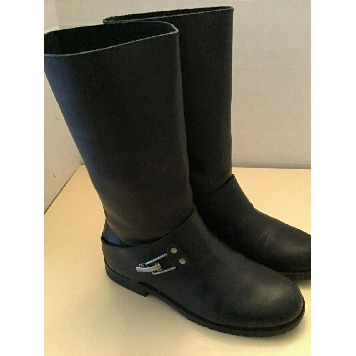 A pair of See by Chloe, size 7, black leather moto style boots with pull on closure, rounded toes, 1" block heels, and chrome buckles