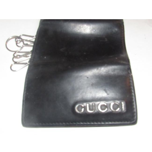 Gucci, black leather, snap close, tri-fold, key holder/card holder, mini- wallet w chrome accents & slots for your cards & six key holders