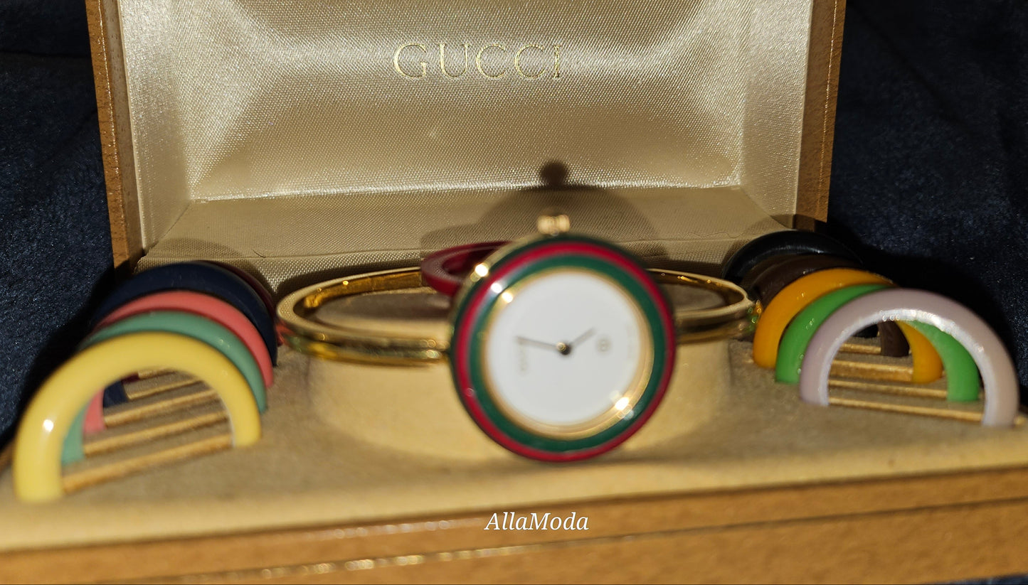 Gucci 1100- I, yellow gold, bangle style watch with twelve different colored, hard plastic resin bands
