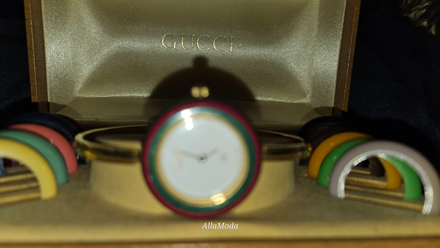 Gucci 1100- I, yellow gold, bangle style watch with twelve different colored, hard plastic resin bands