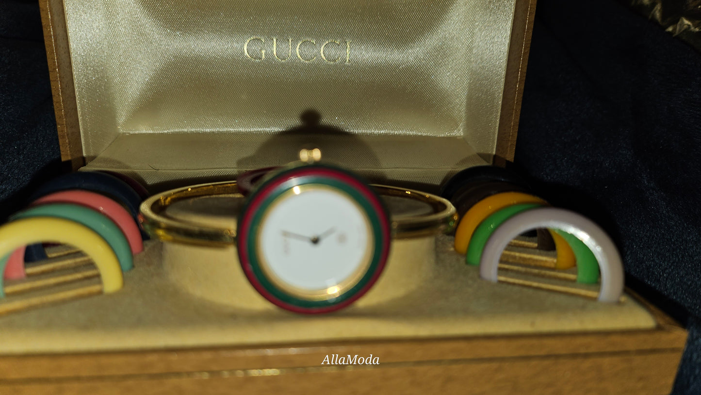 Gucci 1100- I, yellow gold, bangle style watch with twelve different colored, hard plastic resin bands