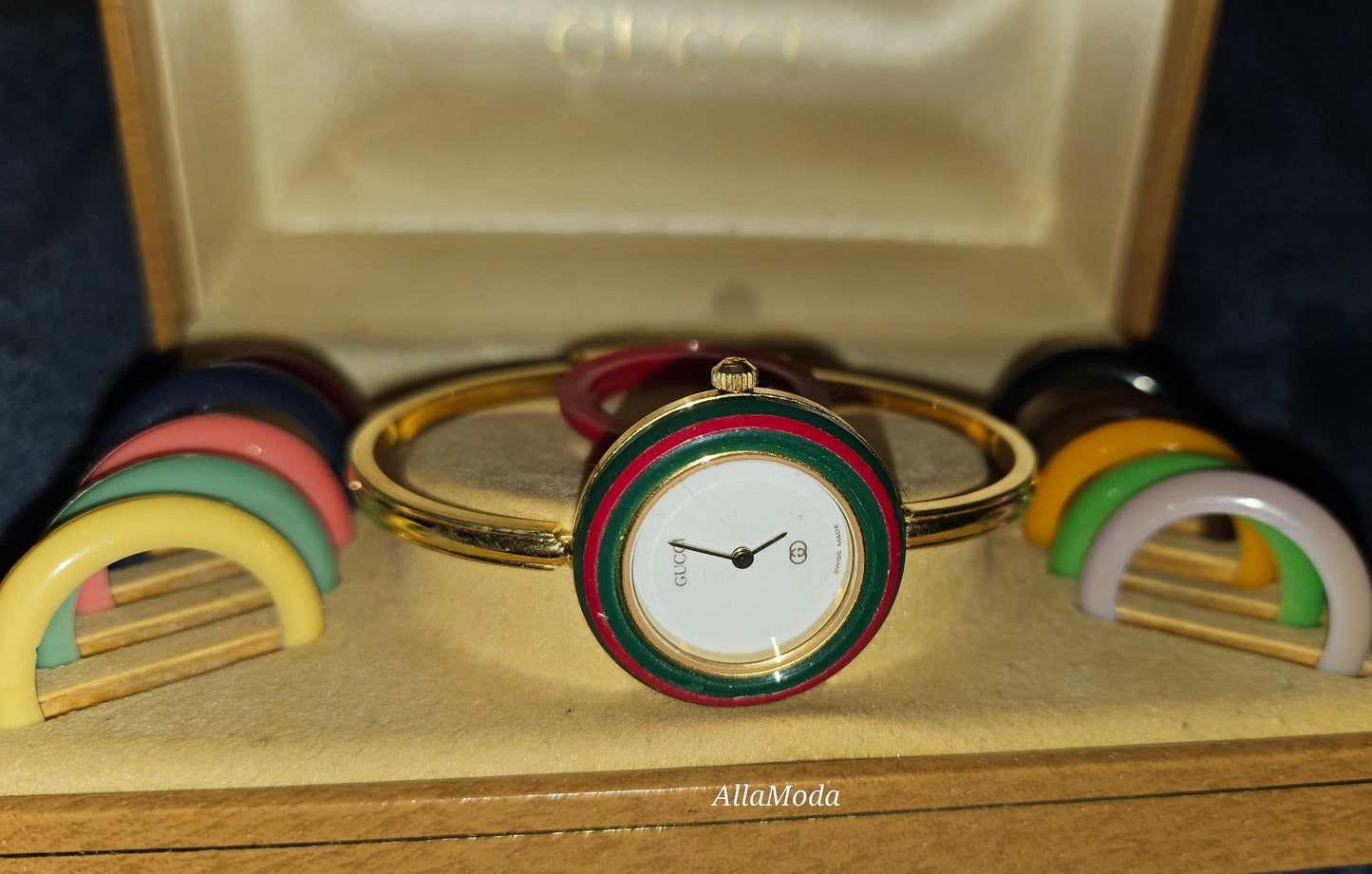 Gucci 1100- I, yellow gold, bangle style watch with twelve different colored, hard plastic resin bands