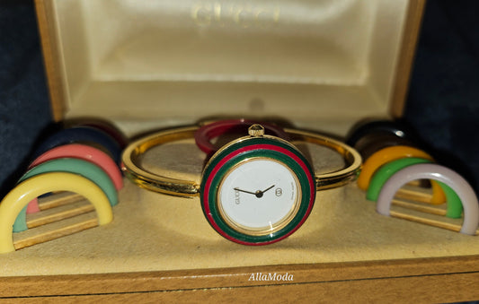 Gucci 1100- I, yellow gold, bangle style watch with twelve different colored, hard plastic resin bands