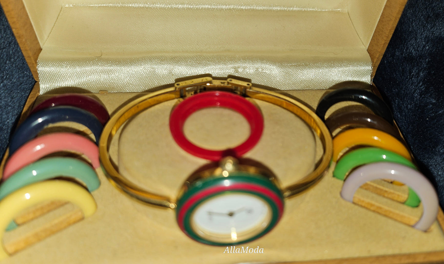 Gucci 1100- I, yellow gold, bangle style watch with twelve different colored, hard plastic resin bands