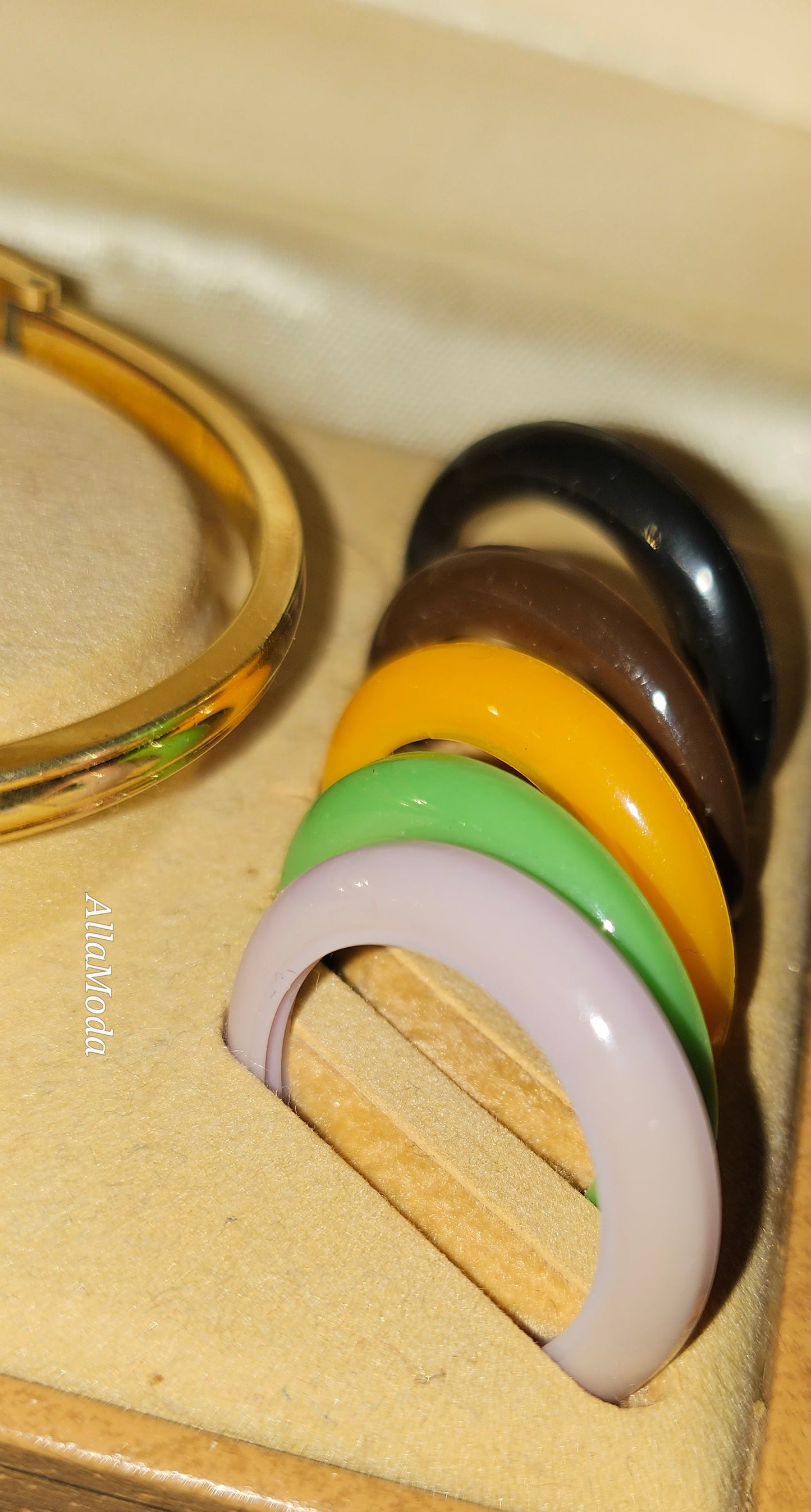 Gucci 1100- I, yellow gold, bangle style watch with twelve different colored, hard plastic resin bands