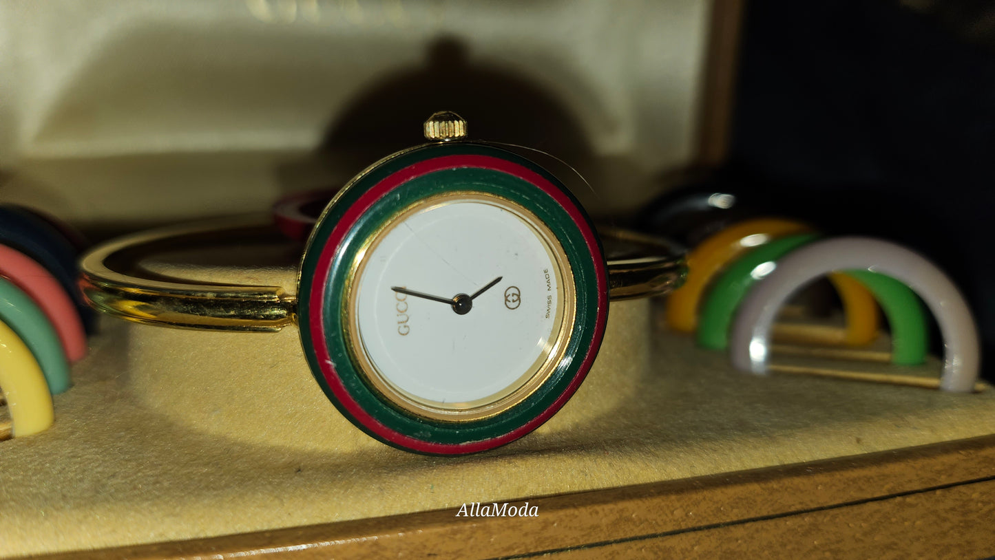 Gucci 1100- I, yellow gold, bangle style watch with twelve different colored, hard plastic resin bands