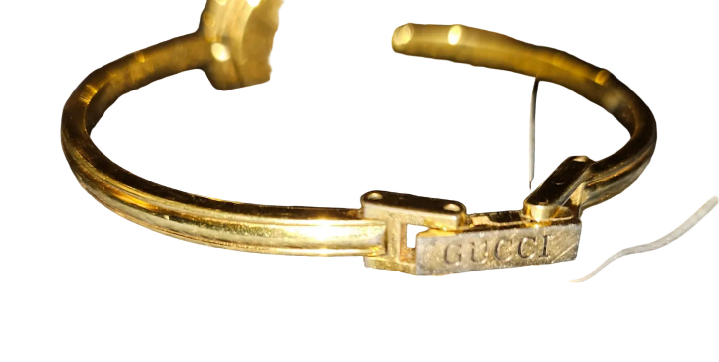 Gucci 1100- I, yellow gold, bangle style watch with twelve different colored, hard plastic resin bands