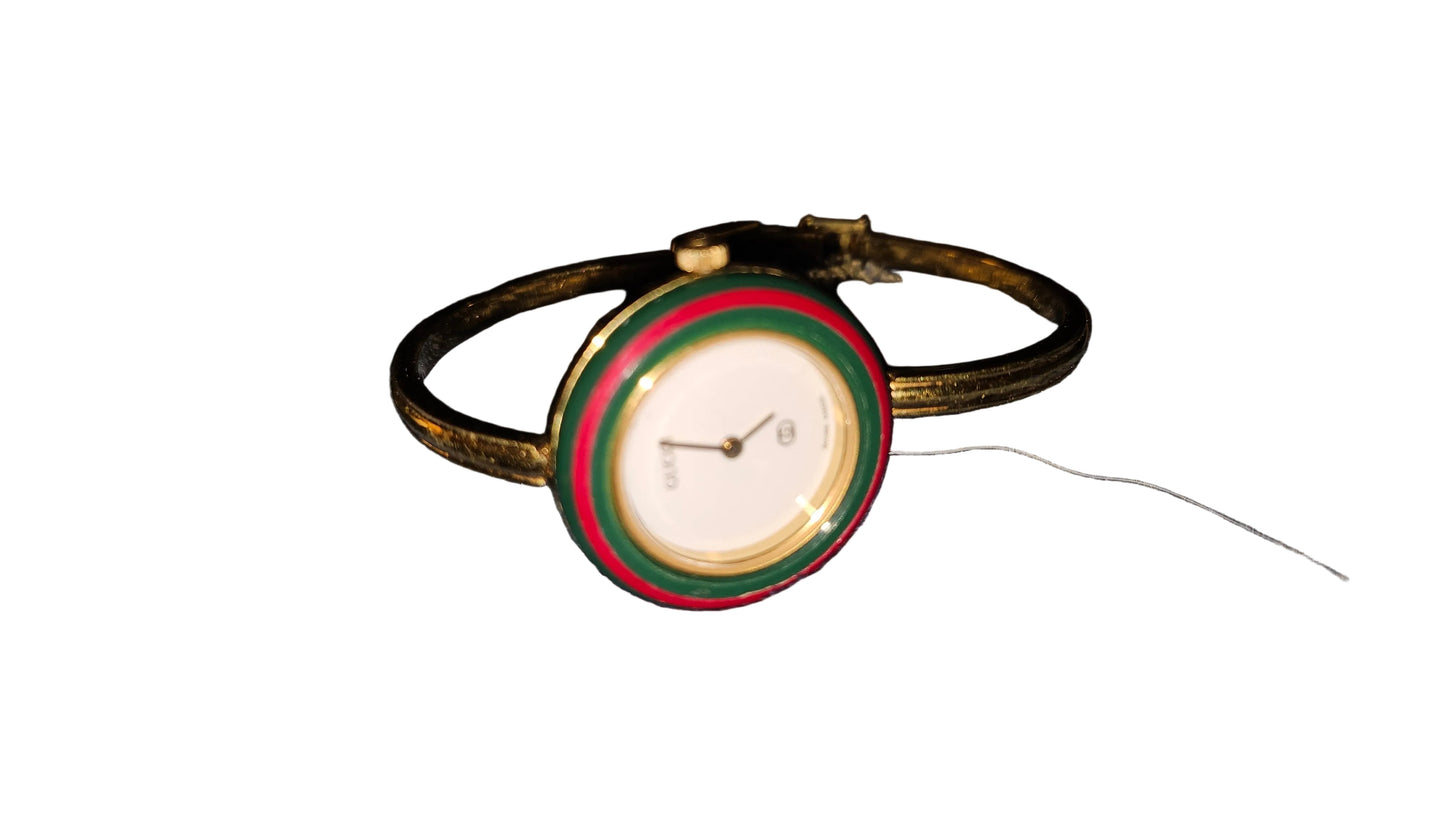 Gucci 1100- I, yellow gold, bangle style watch with twelve different colored, hard plastic resin bands