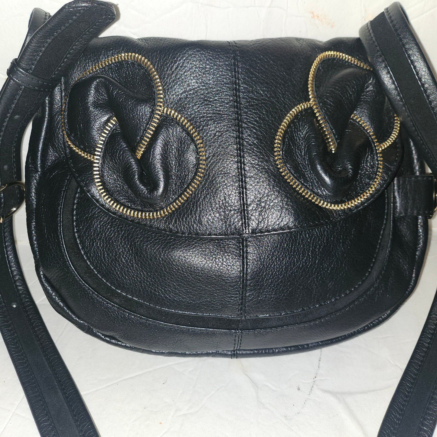 See By Chloe black pebbled leather saddle bag with two leather flowers