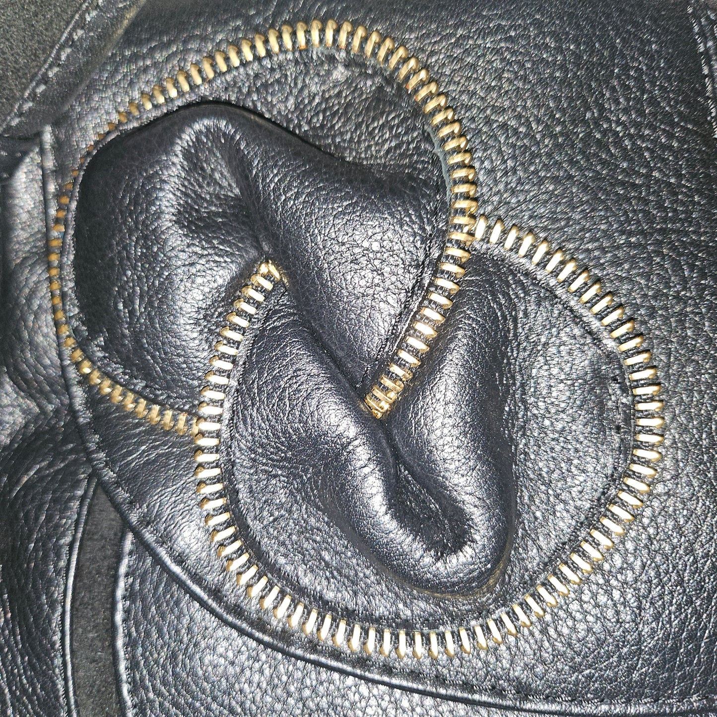 See By Chloe black pebbled leather saddle bag with two leather flowers