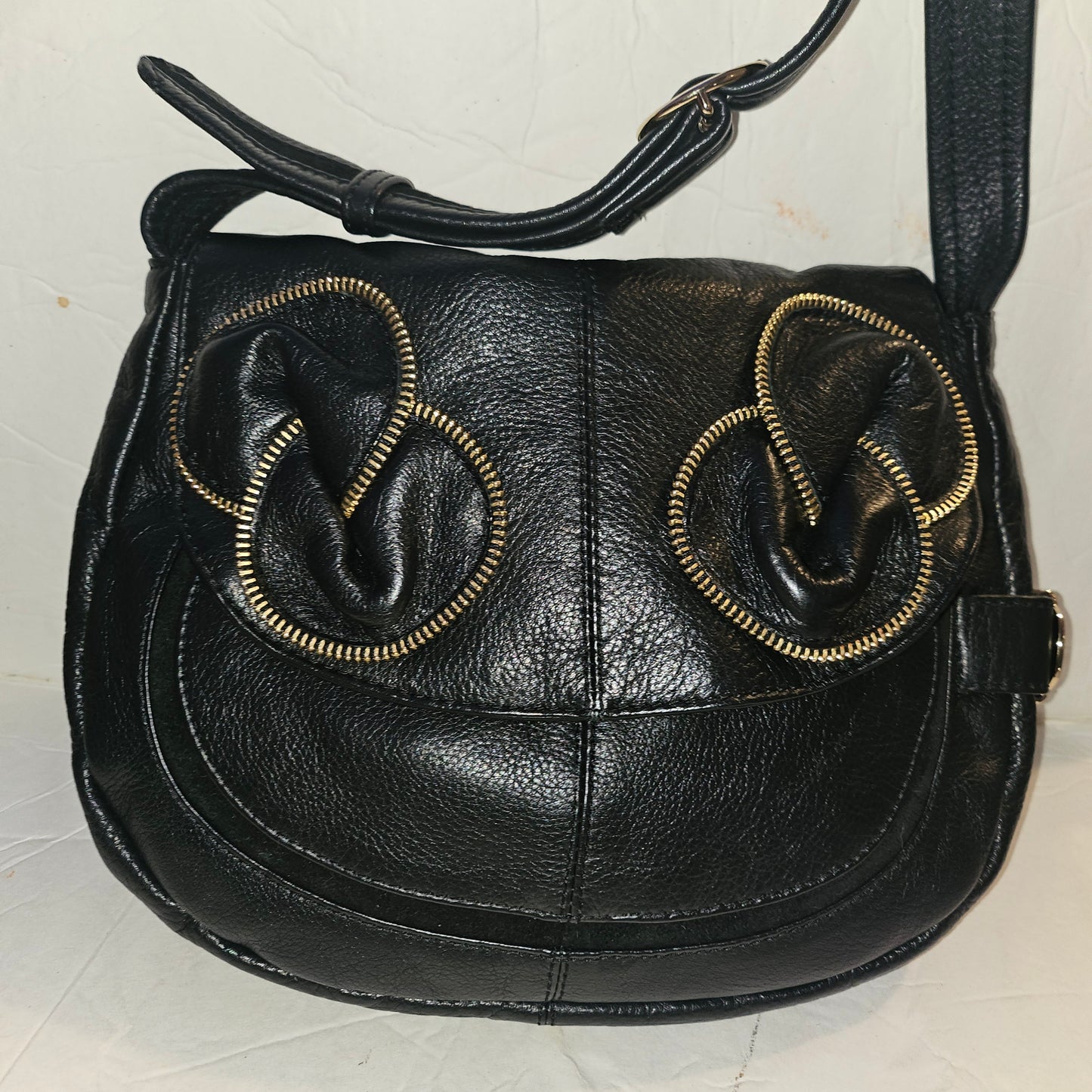 See By Chloe black pebbled leather saddle bag with two leather flowers