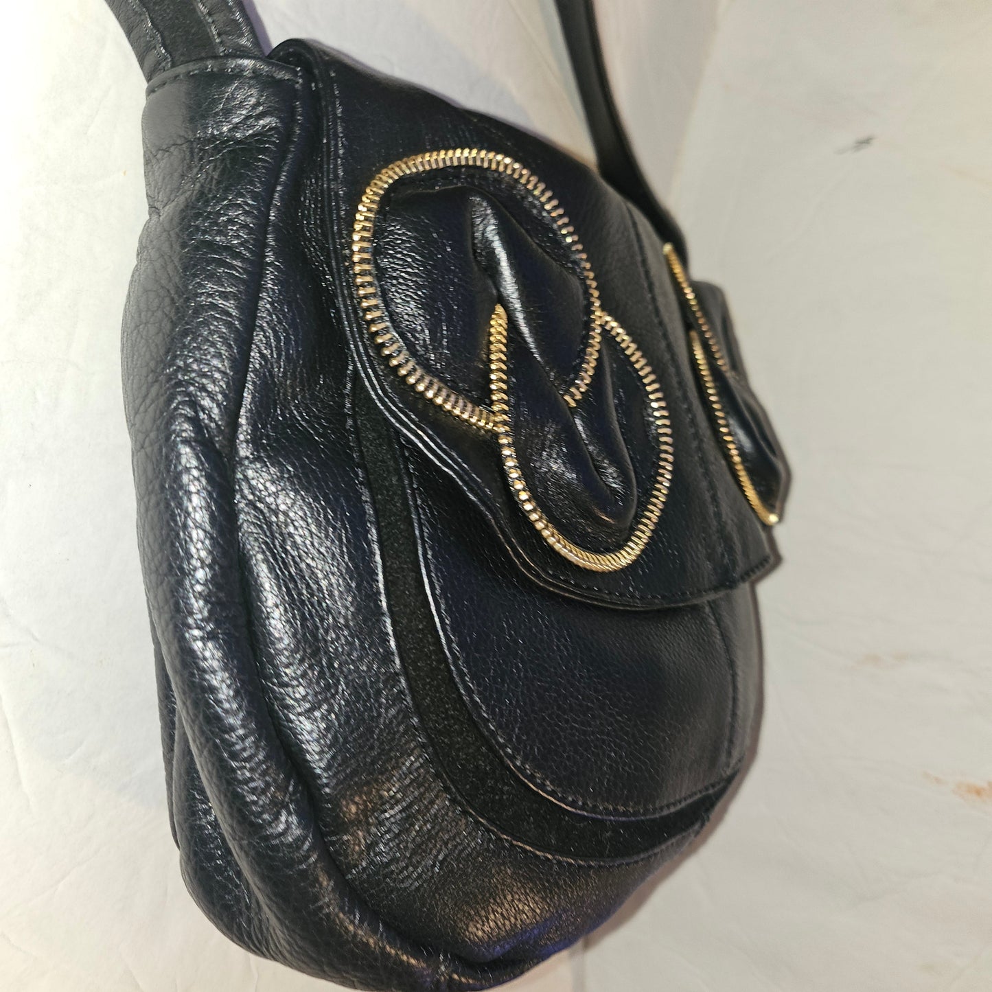 See By Chloe black pebbled leather saddle bag with two leather flowers