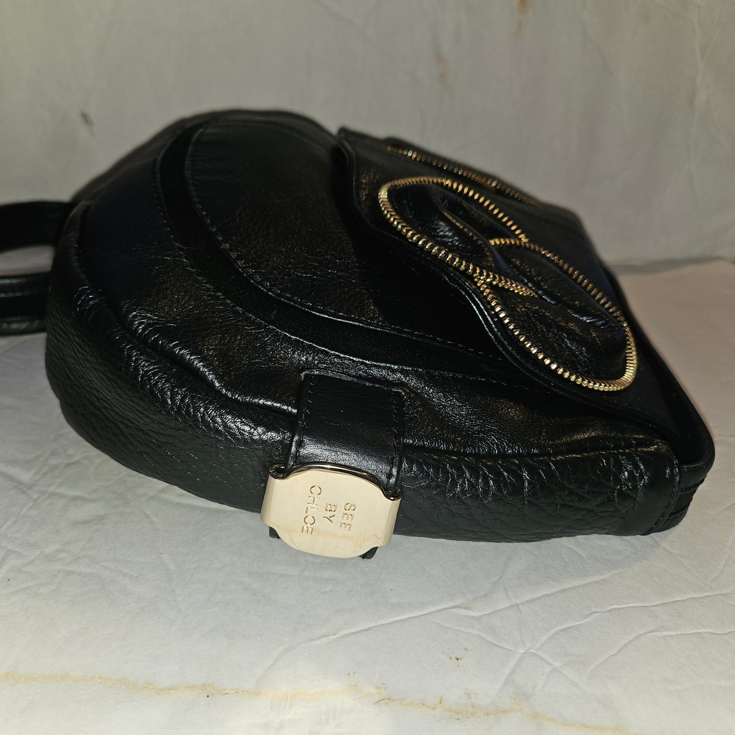 See By Chloe black pebbled leather saddle bag with two leather flowers