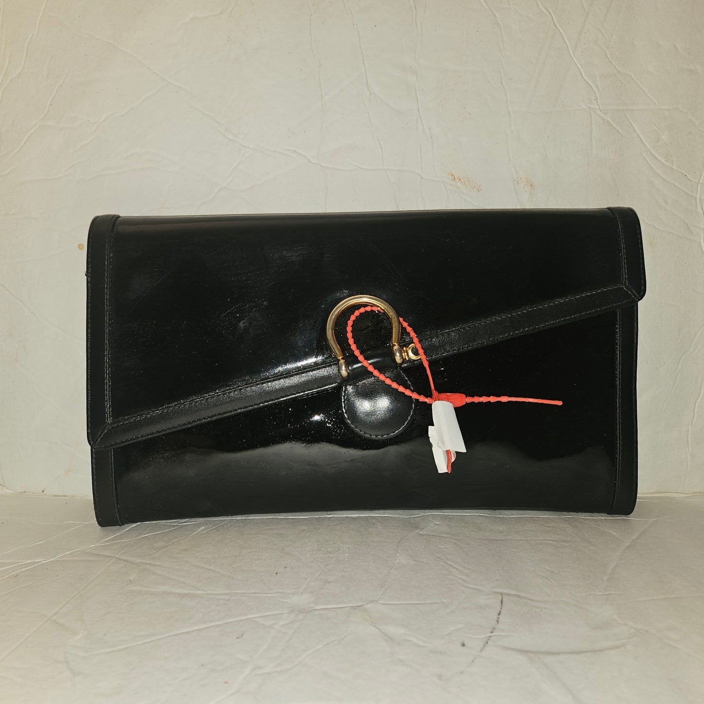 Gucci black patent leather XL asymmetrical envelope top clutch with a gold equestrian accent