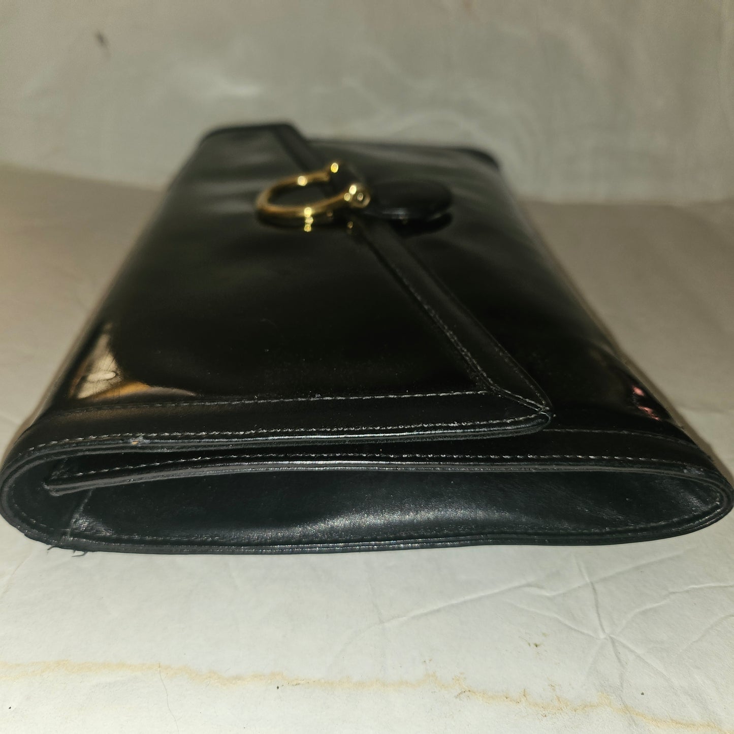 Gucci black patent leather XL asymmetrical envelope top clutch with a gold equestrian accent