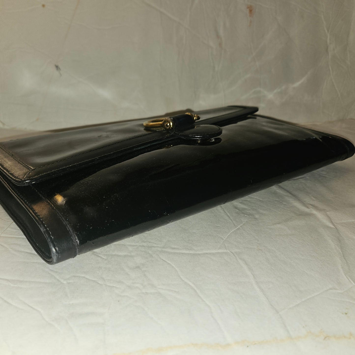 Gucci black patent leather XL asymmetrical envelope top clutch with a gold equestrian accent