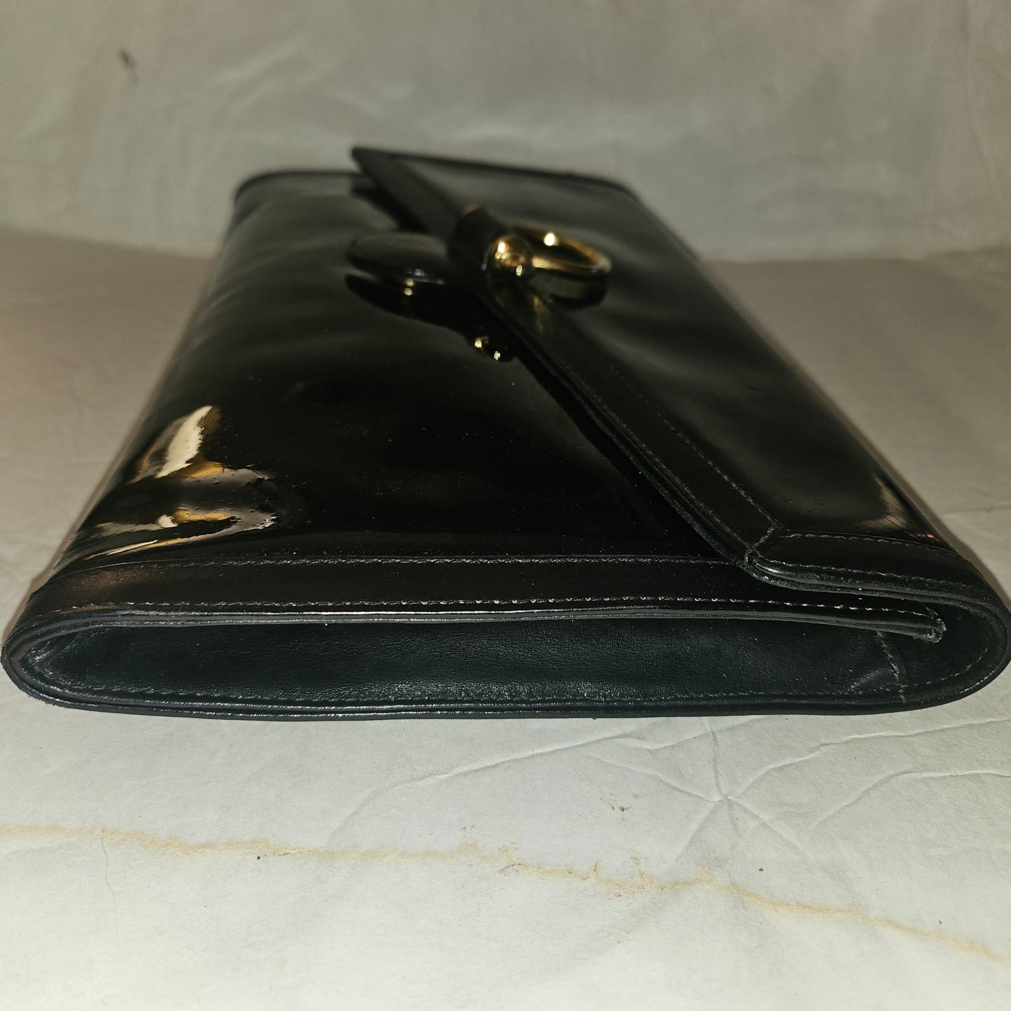 Gucci black patent leather XL asymmetrical envelope top clutch with a gold equestrian accent
