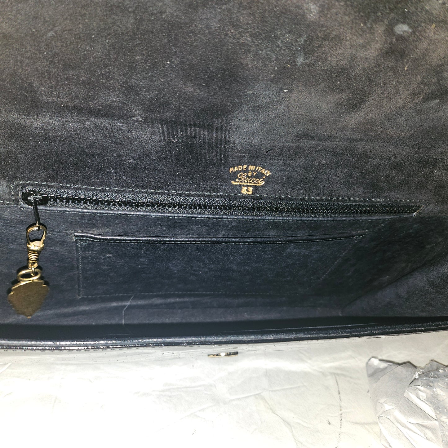 Gucci black patent leather XL asymmetrical envelope top clutch with a gold equestrian accent