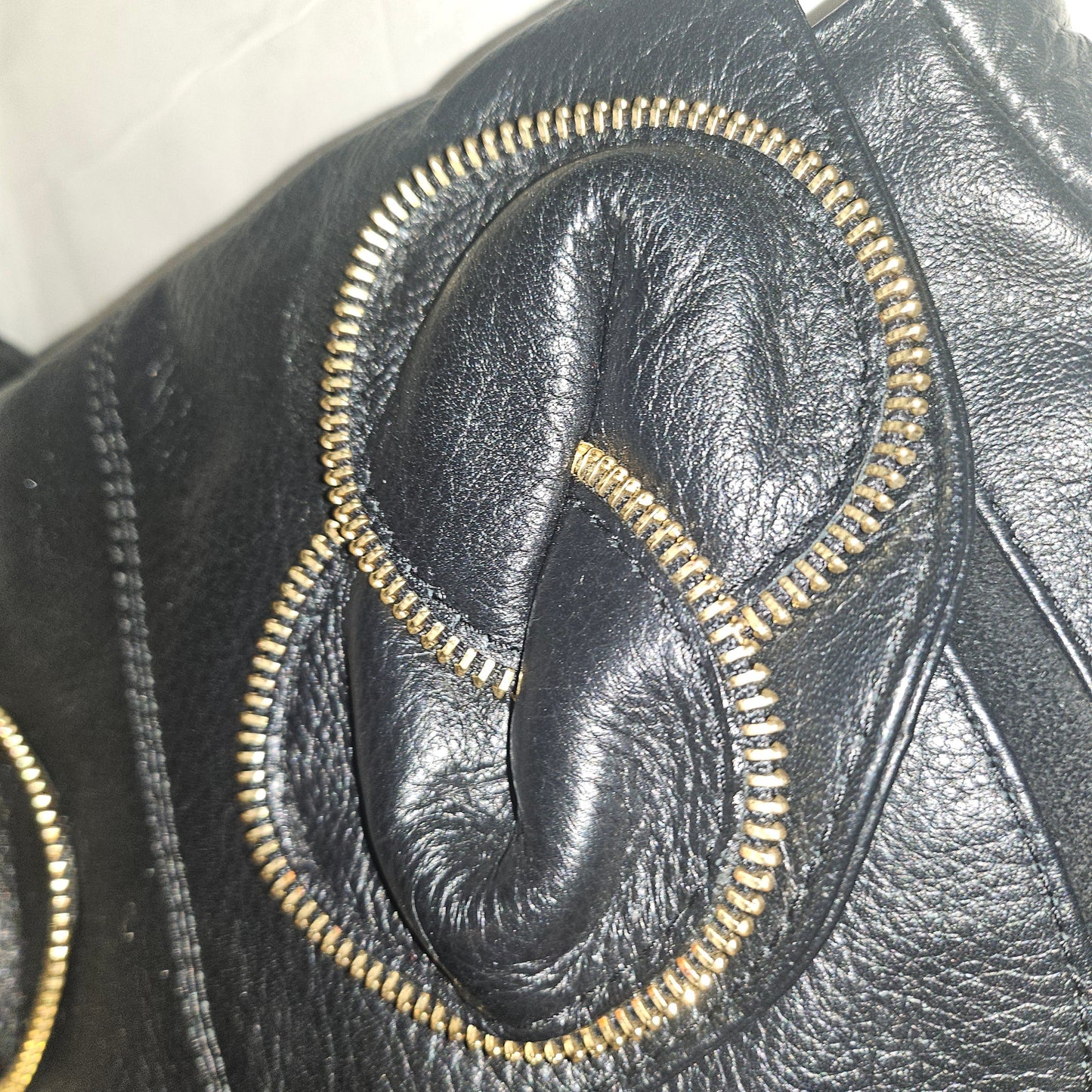See By Chloe black pebbled leather saddle bag with two leather flowers