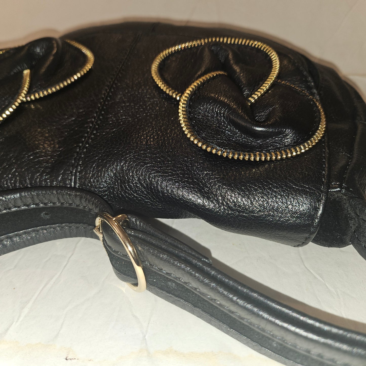 See By Chloe black pebbled leather saddle bag with two leather flowers