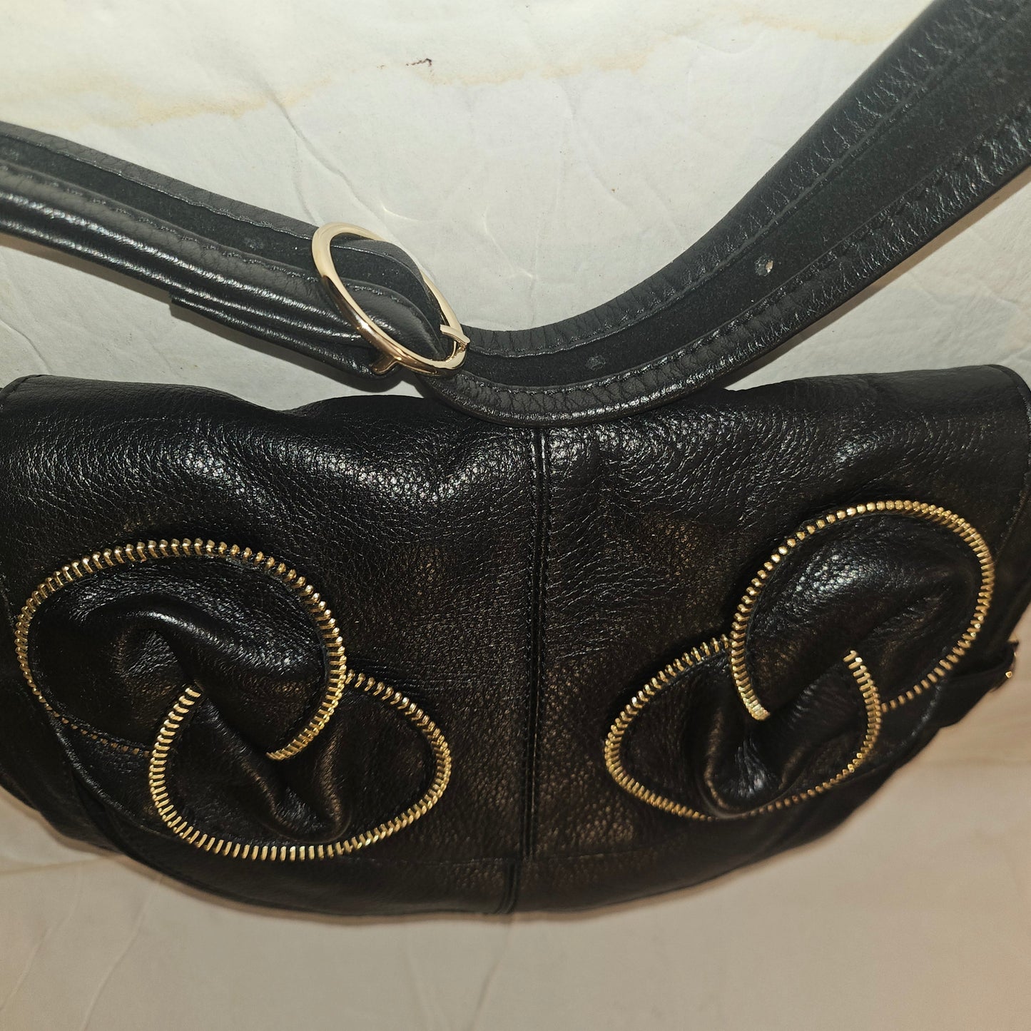 See By Chloe black pebbled leather saddle bag with two leather flowers