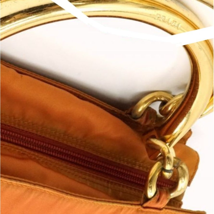 Prada orange re-edition 2000 satchel with gold metal handles