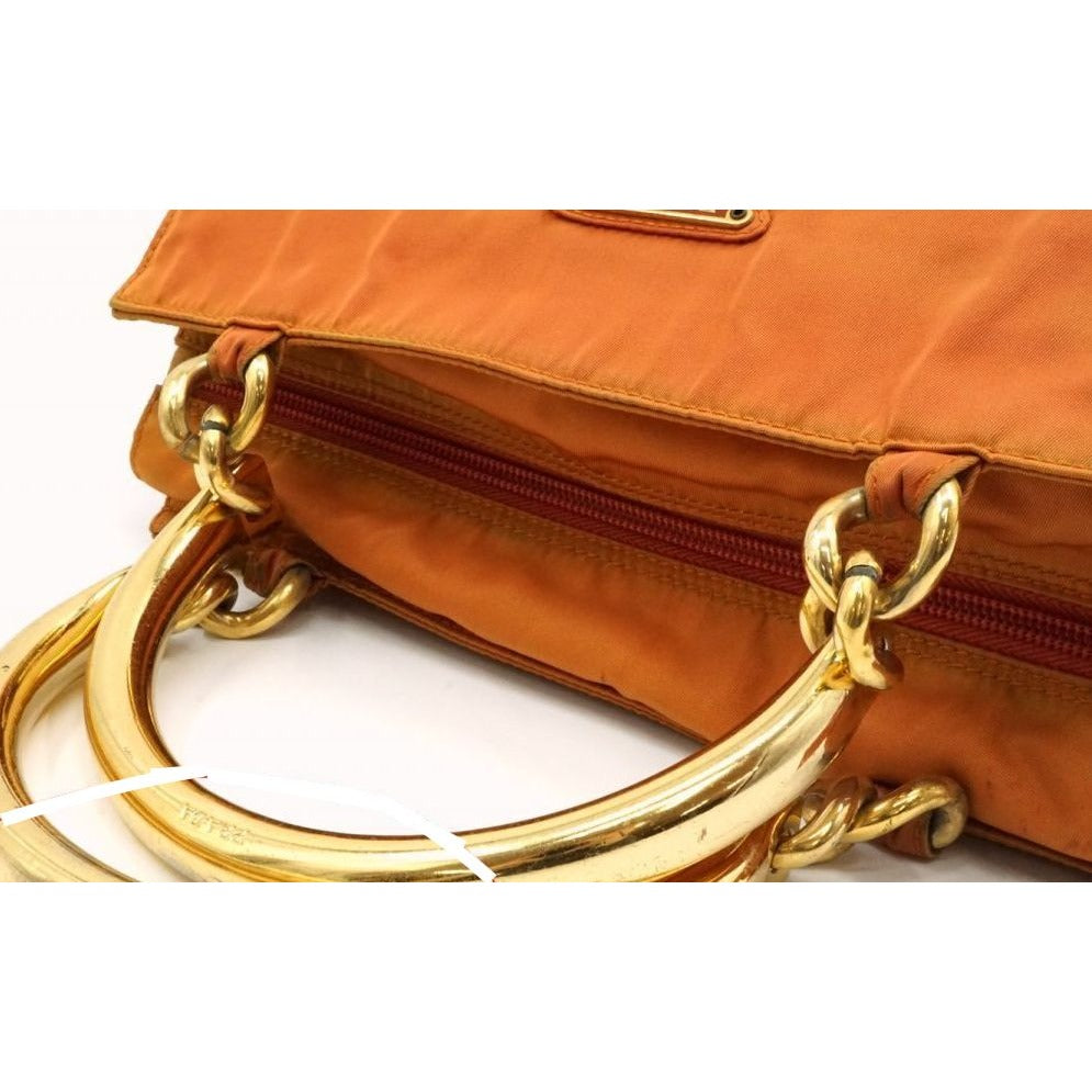 Prada orange re-edition 2000 satchel with gold metal handles