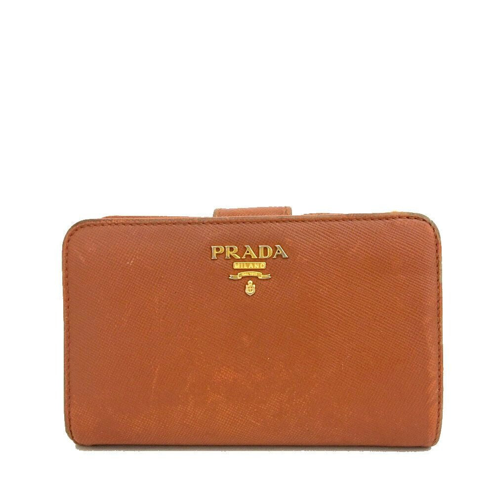 PRADA, burnt orange, saffiano leather, zip around style, large wallet w lots of compartments, zip pockets, card slots, & gold hardware