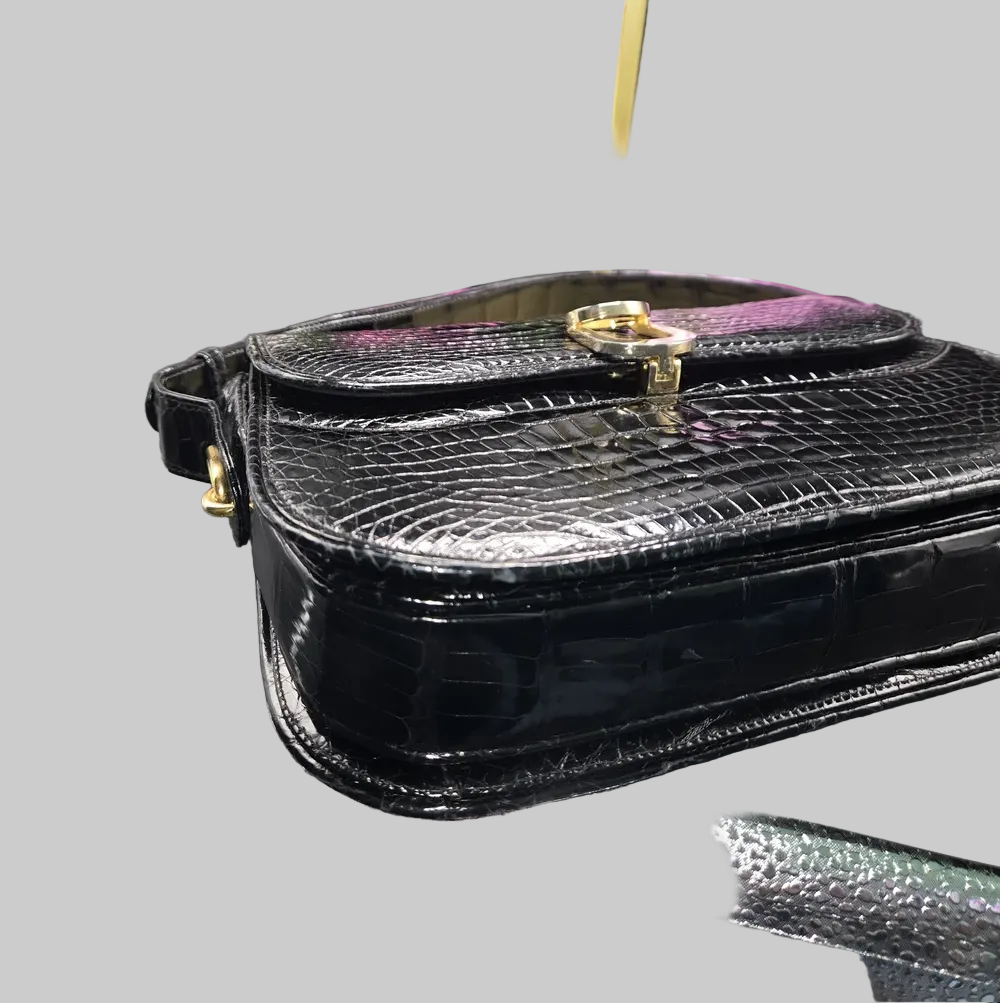 Gucci black crocodile leather shoulder purse with a bold gold 'G' accent
