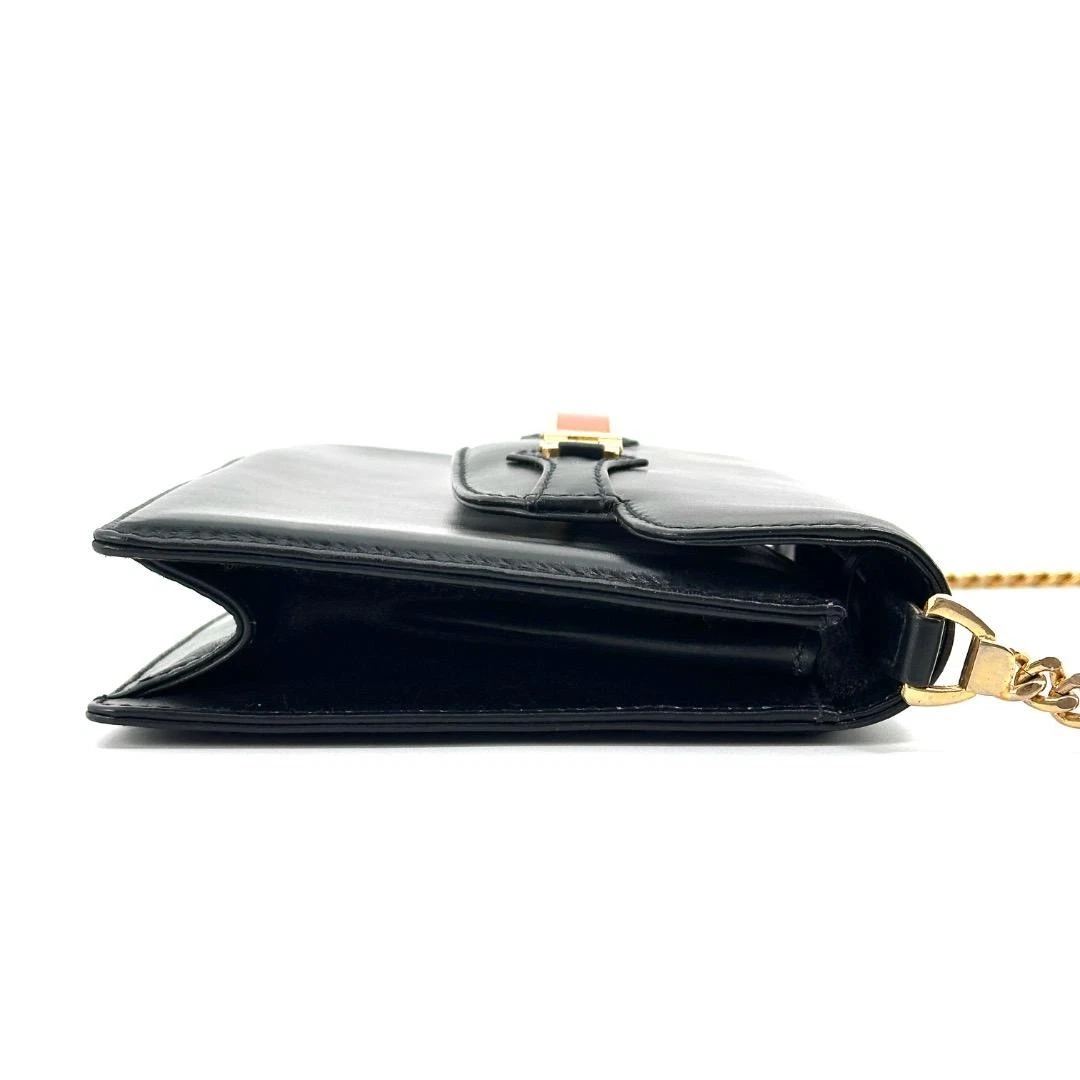 Gucci black leather two-way  mini purse with a yellow enamel clasp