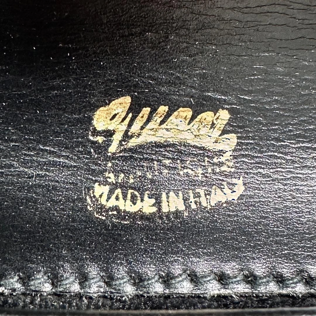 Gucci black leather two-way  mini purse with a yellow enamel clasp