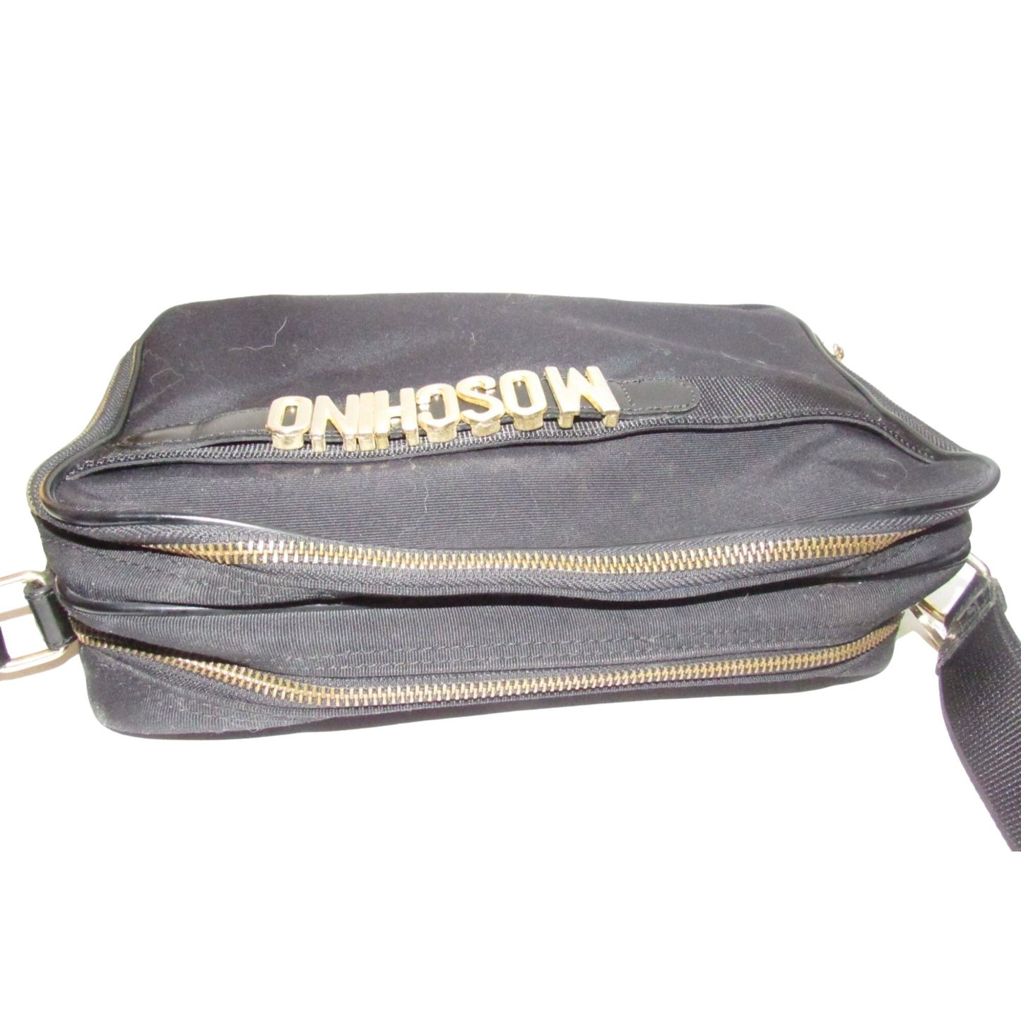 Moschino, black canvas & leather, cross body with a zip top, bold, gold, MOSCHINO letter accents, & a long strap with snaps on both sides
