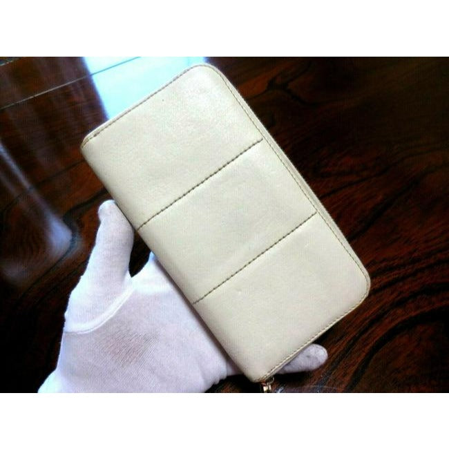 Salvatore Ferragamo White Leather With Brown Contrast Stitching And A Quilted Double Gancini Zip Around Wallet