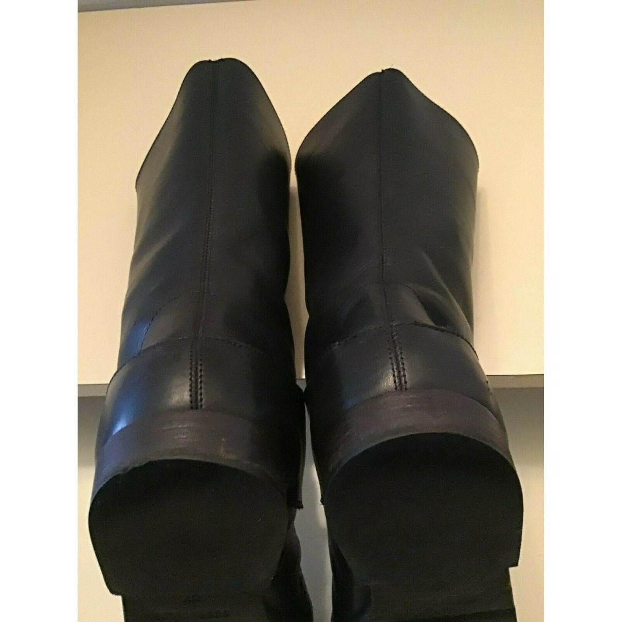 A pair of See by Chloe, size 7, black leather moto style boots with pull on closure, rounded toes, 1" block heels, and chrome buckles