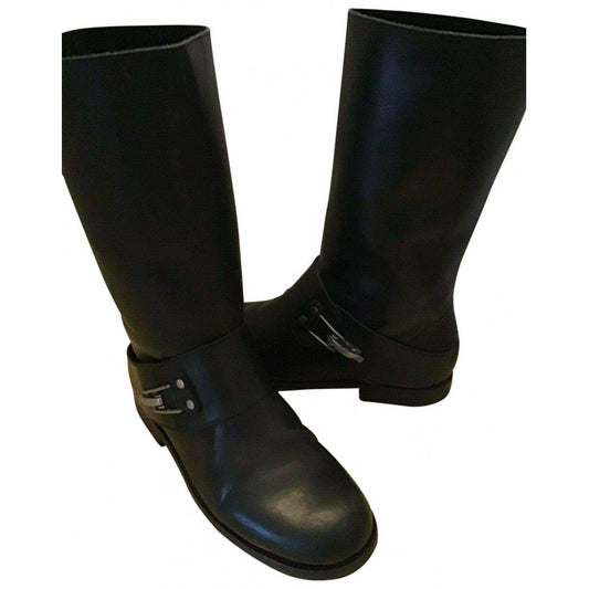 A pair of See by Chloe, size 7, black leather moto style boots with pull on closure, rounded toes, 1" block heels, and chrome buckles