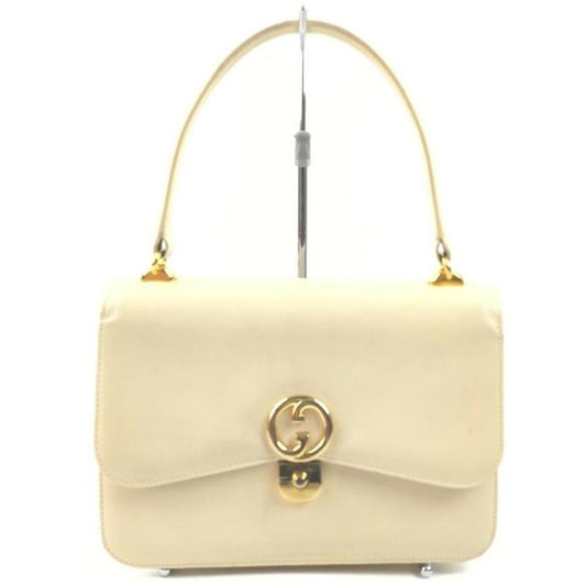 Vintage, Gucci, cream leather, 1973 top handle style purse with gold tone accents!